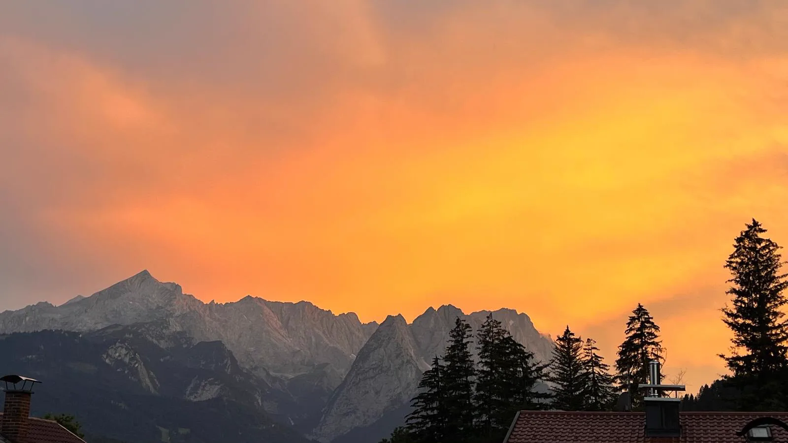 Wettersteingebirge unter einem leuchtend orangefarbenen Abendhimmel